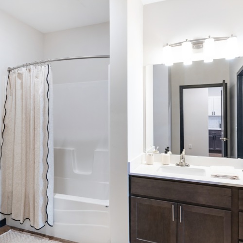 a bathroom with a shower/tub combo
