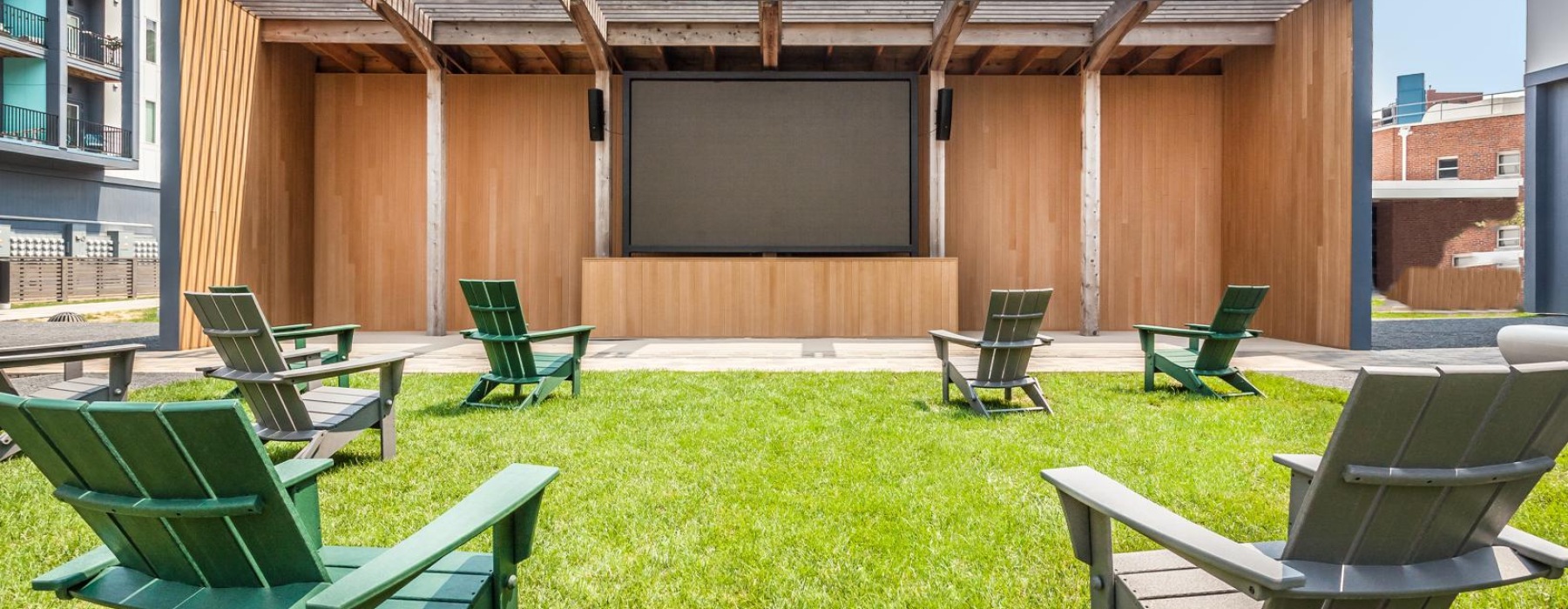 lawn with chairs scattered facing large movie screen