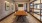 well lit conference room with long table surrounded by chairs